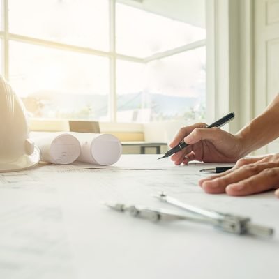 Hands of Engineer working on blueprint,Construction concept. Eng Hands of Engineer working on blueprint,Construction concept. Engineering tools.Vintage tone retro filter effect,soft focus(selective focus)